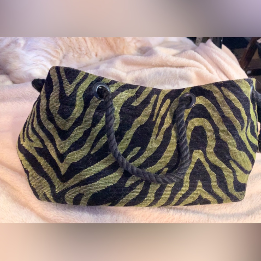 Green and black tiger/zebra print outside with plum purple inside hand bag
